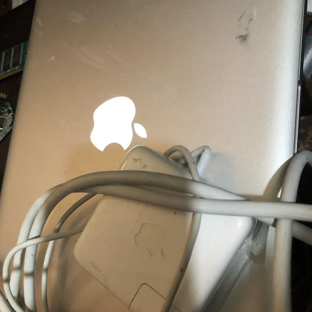 Apple MacBook with 4 chargers and dell laptop for parts
